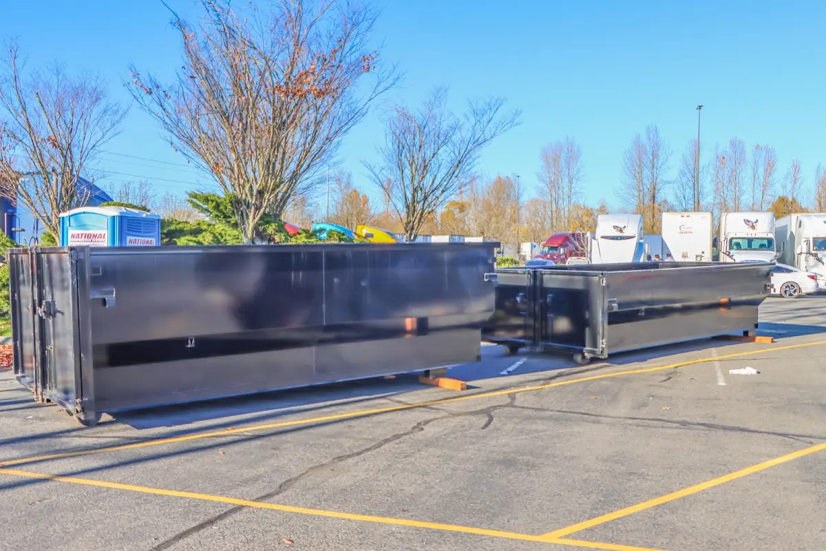 Professional dumpster rental service with roll-off container on residential driveway in Vinton